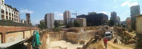 Surveyor with total station at excavation site